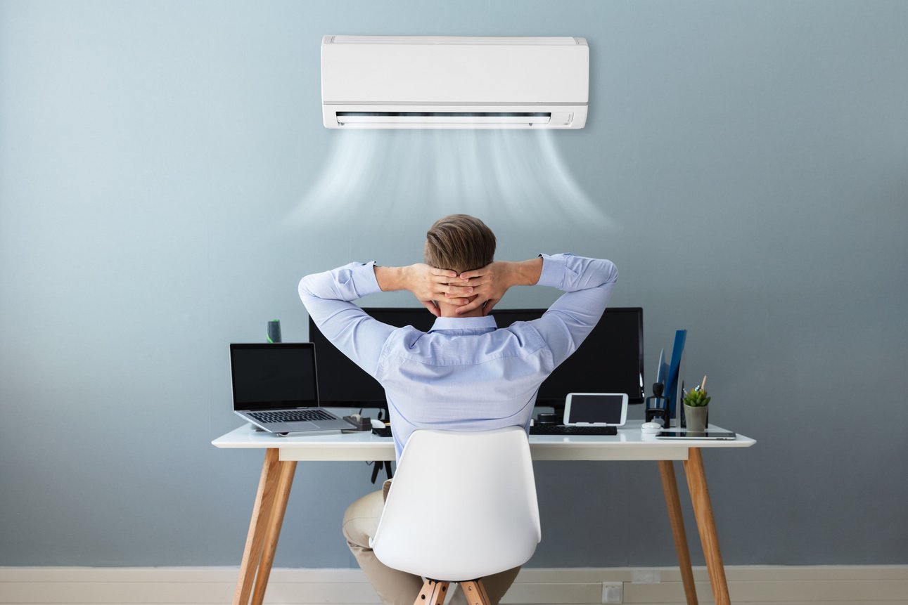 Businessman Relaxing in the Office With Air Conditioning